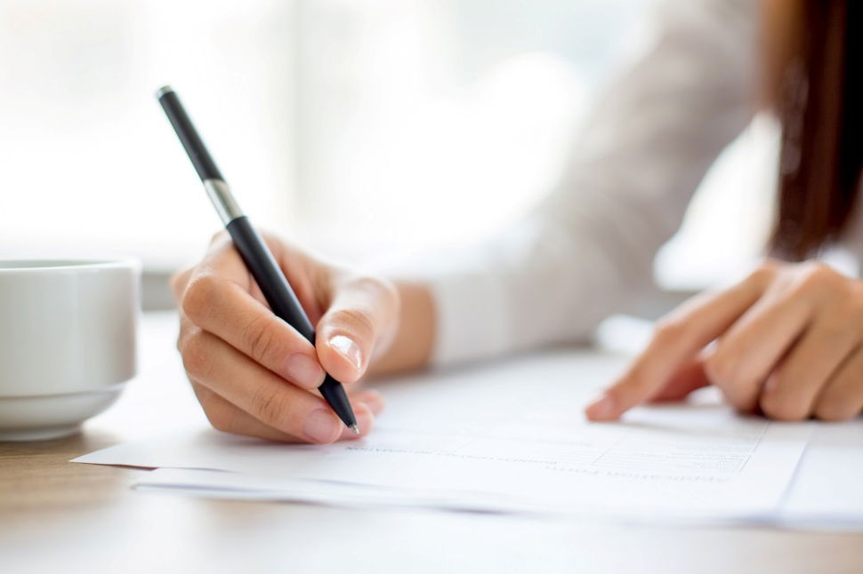 woman writing a dispute letter