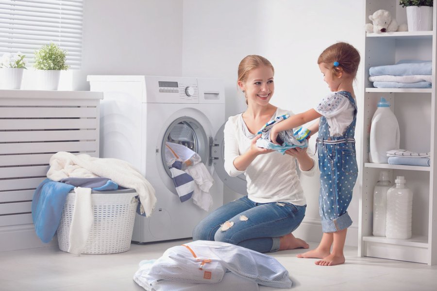 mother and daughter doing laundry