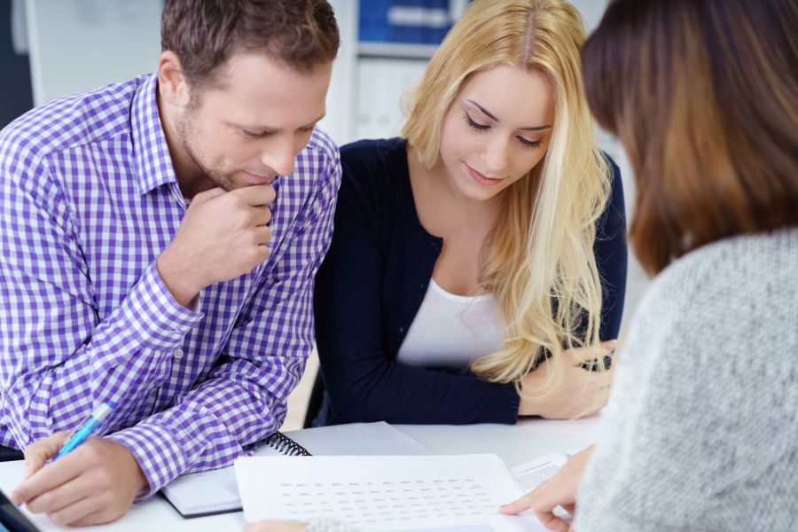 couple signing mortgage papers