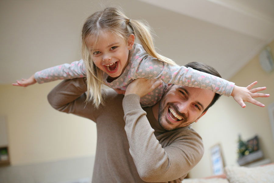 father playing with daughter