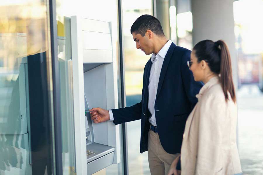 man and woman at ATM