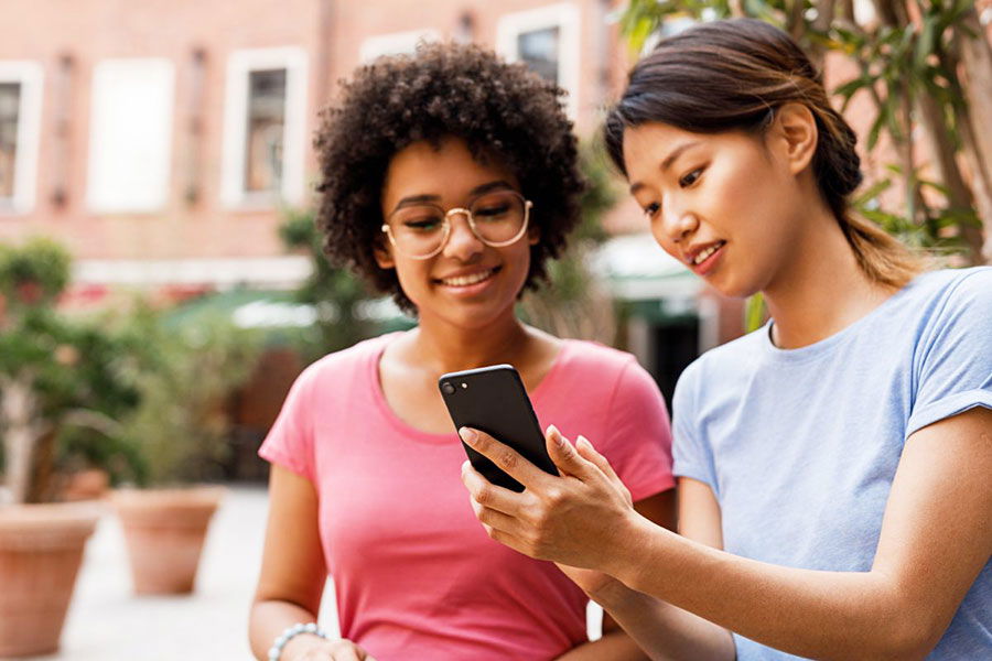 women viewing mobile phone