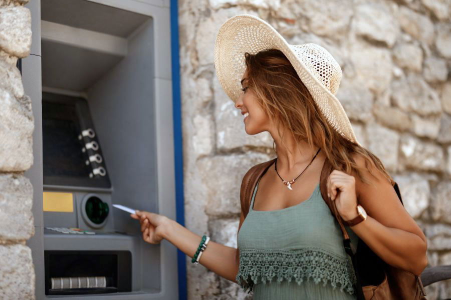 woman using credit card at ATM