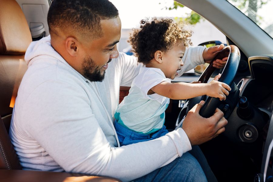 dad and kid driving car