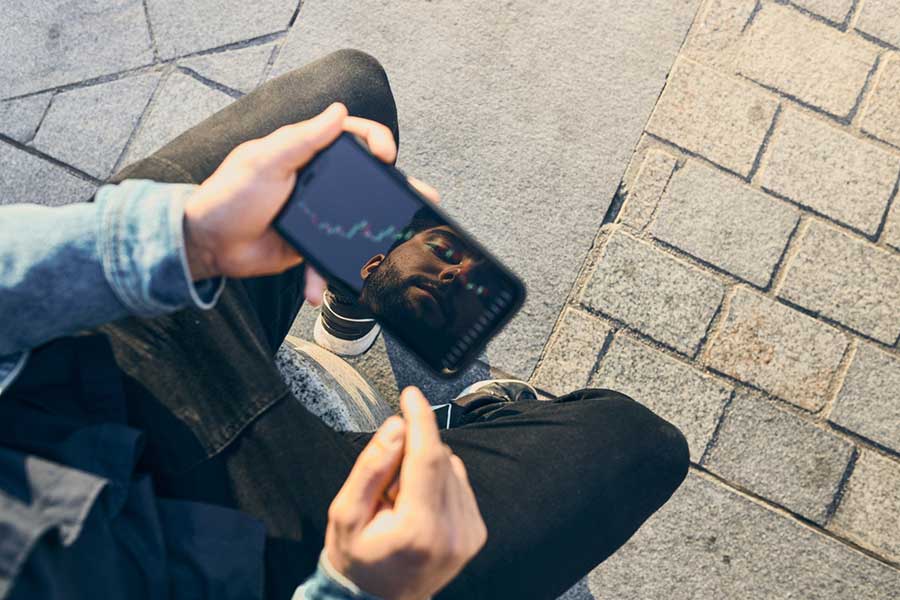 man investing in crypto on phone