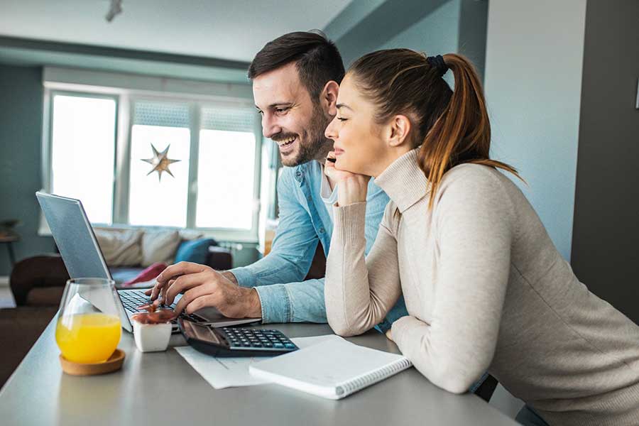 couple budgeting on laptop