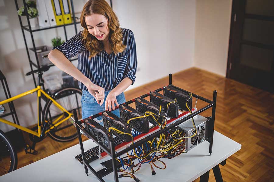 woman setting up bitcoin miner