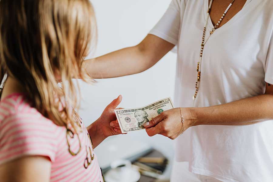 kid getting allowance from mother