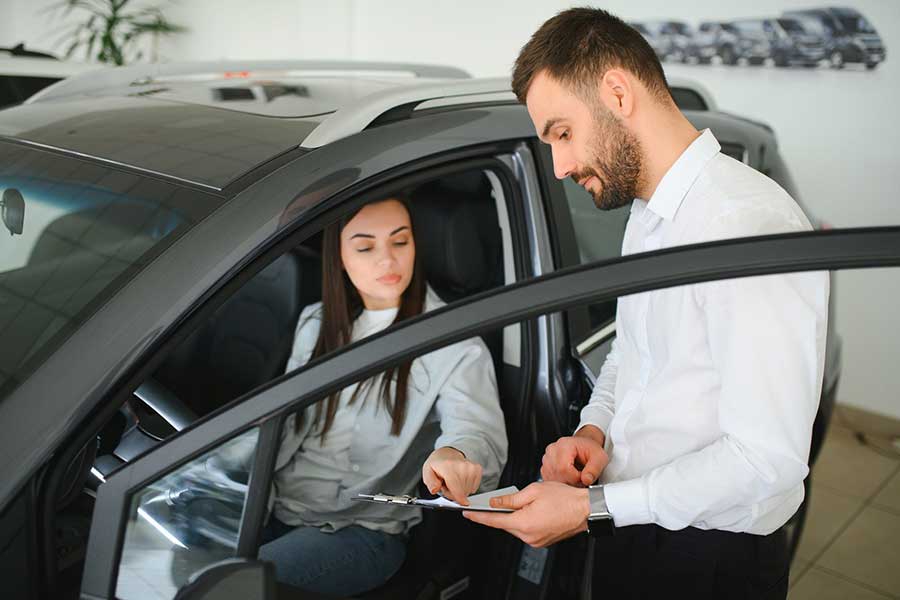 woman at car dealership