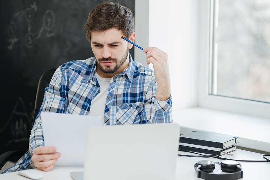man reviewing bank statement