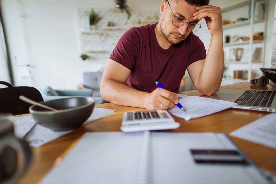 man reviewing bills at home