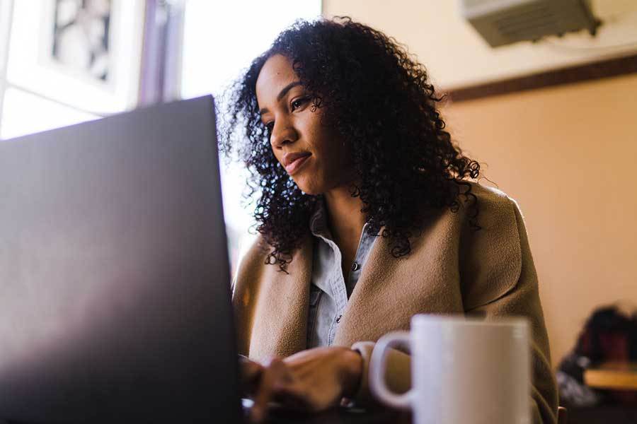 woman checking credit on laptop