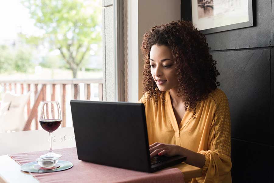 woman checking credit score on laptop