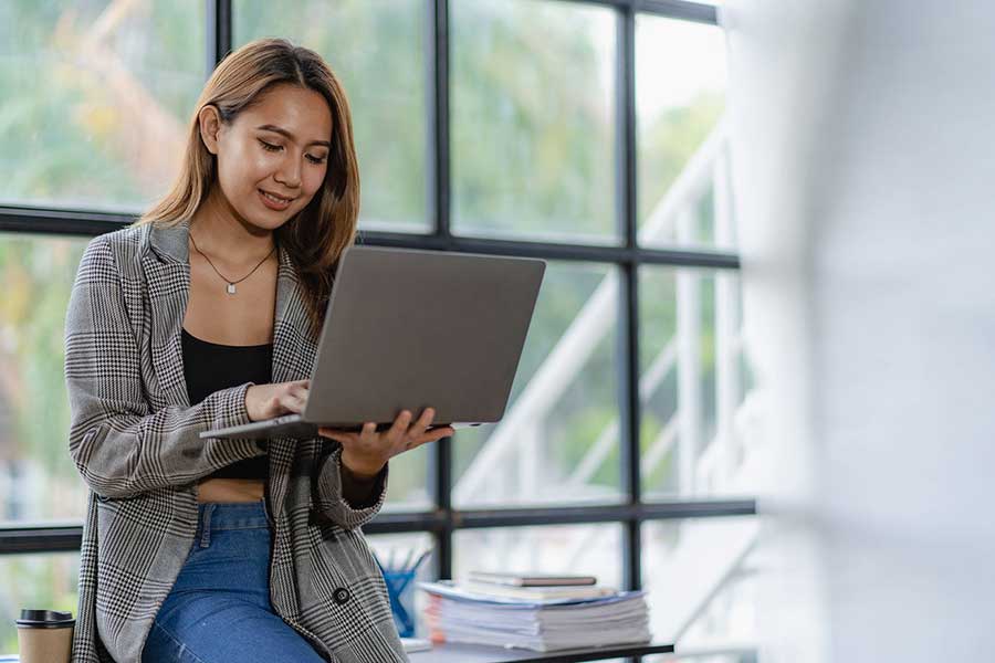 woman reviewing balance sheet on laptop