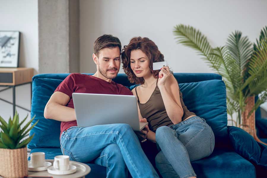 couple comparing credit cards at home