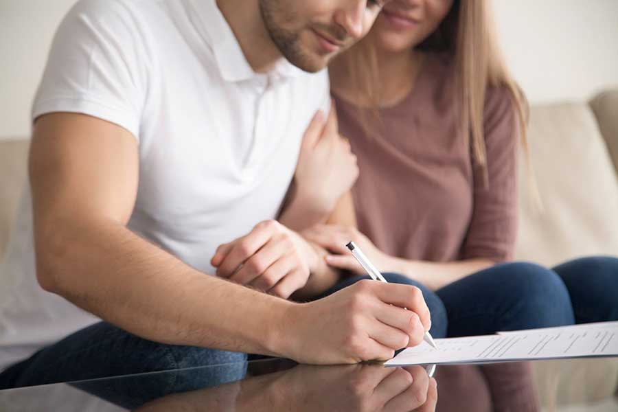 couple signing paperwork for a loan