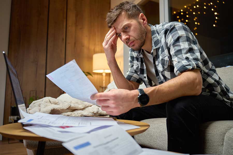man looking at credit card bill