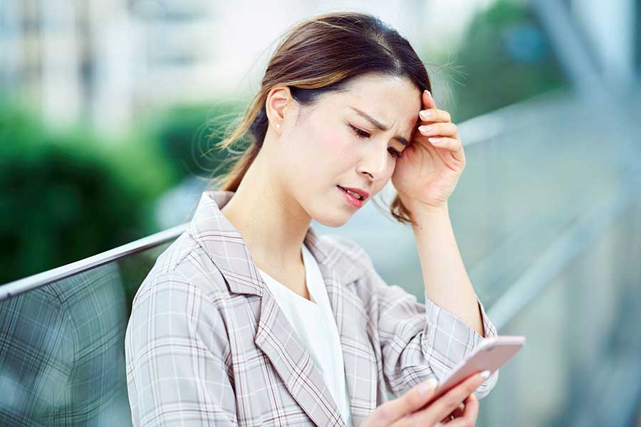 woman checking bank account on phone
