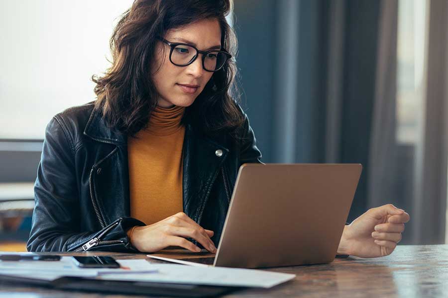 woman checking credit report on laptop