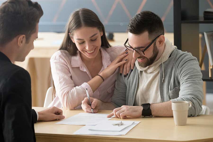 couple signing home closing documents